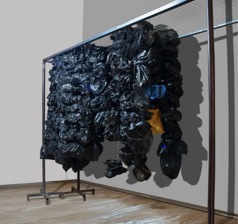 Sculptural installation titled Cashless Society Bags (2024) by Amarachi Okafor, measuring 230 x 206 x 50 cm. The artwork consists of numerous black plastic bags tightly bundled together and suspended from a metal frame, with occasional blue and yellow bags interspersed. 